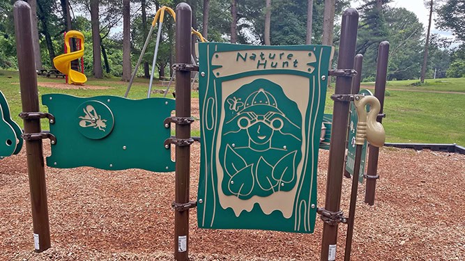 Nature-themed sensory playground area with Nature Hunt Label