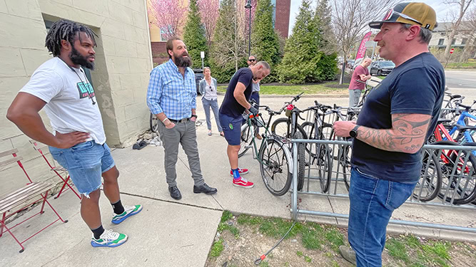 Office of Outdoor Recreation Director Dr. Nathan Reigner speaks with outdoor economy stakeholders. Bicycles appear behind.